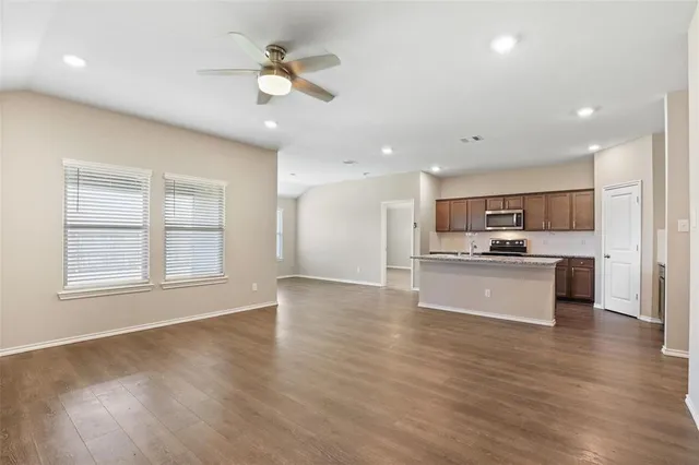 a view of kitchen with refrigerator microwave and stove