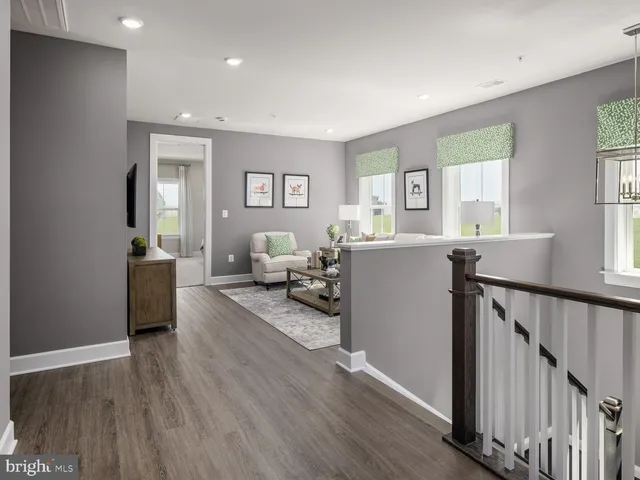 a view of a livingroom with furniture and hardwood floor
