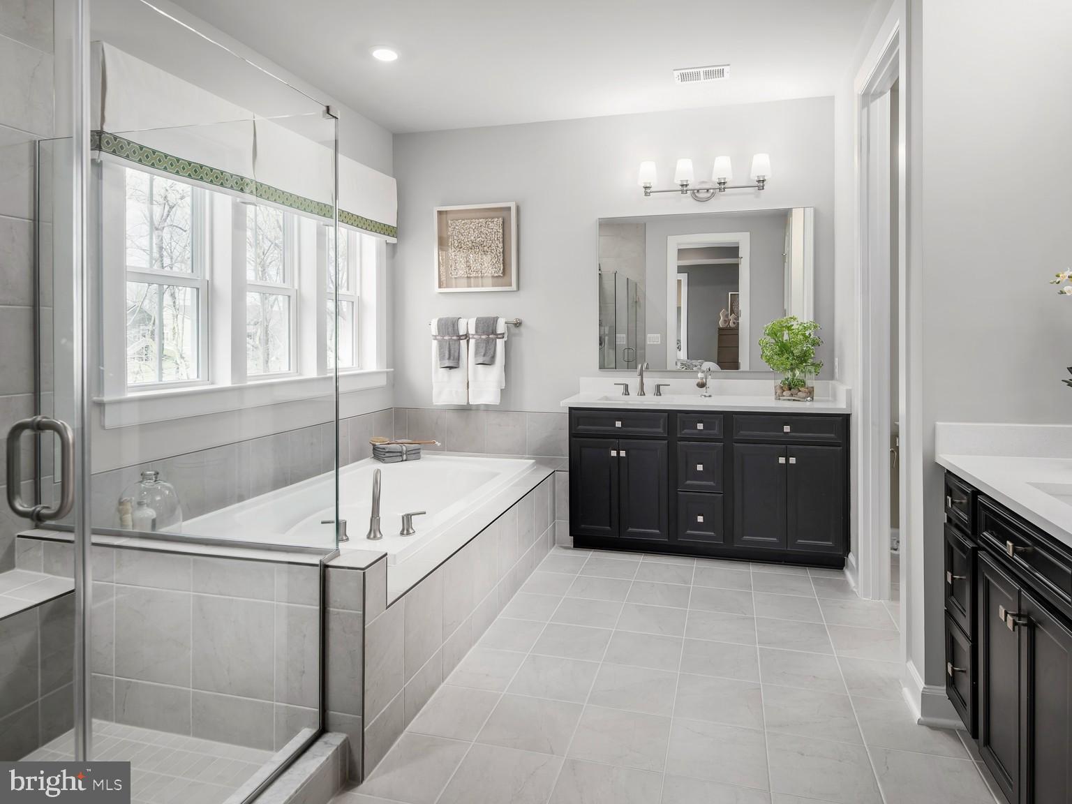 1221 Bear Branch Road Laurel, MD 20708 - Photo 13 of 22 a spacious bathroom with a tub sink shower and mirror