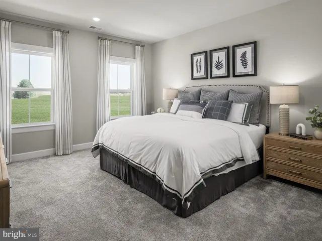 a spacious bedroom with a bed and window