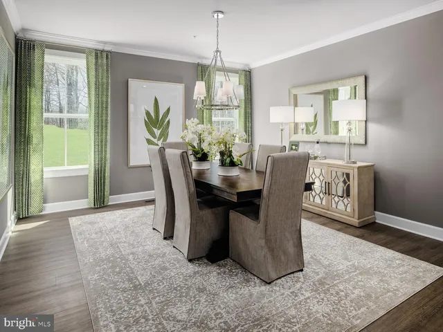 a dining room with furniture a chandelier and wooden floor