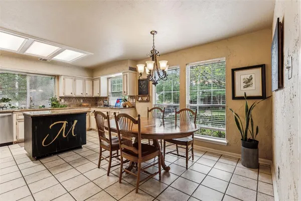 a dining room with furniture and window