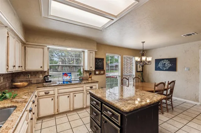 a kitchen with granite countertop a sink and cabinets