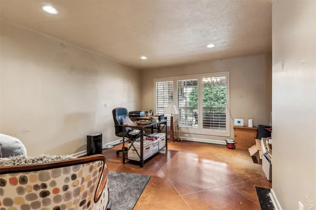 a view of a workspace with furniture and a window