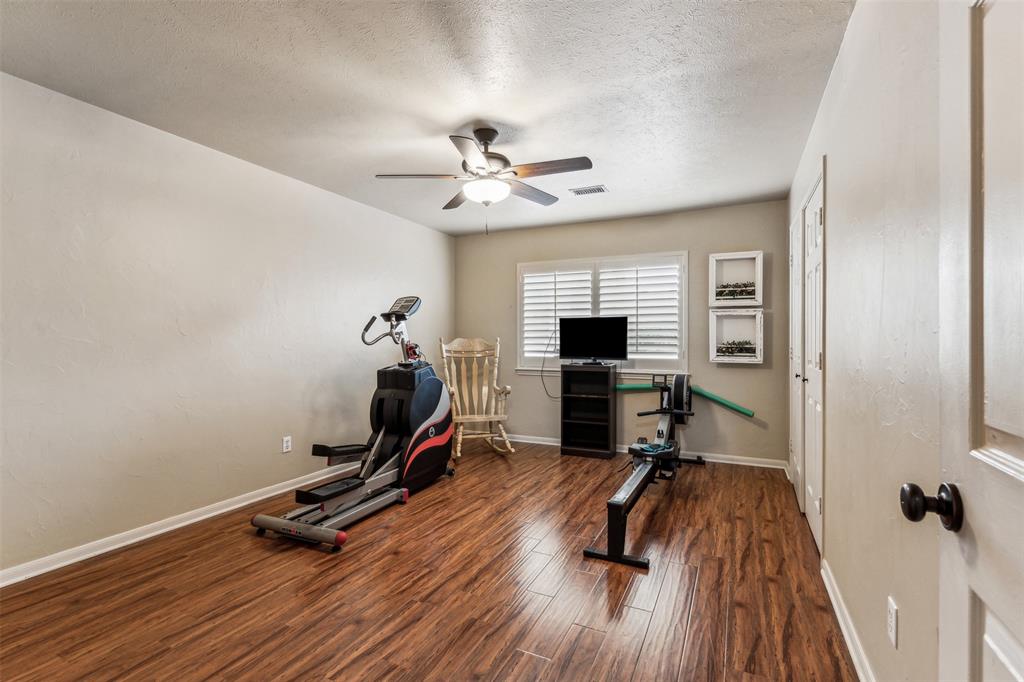 5109 Dewdrop Lane Fort Worth, TX 76123 - Photo 25 of 40 a view of a room with gym equipment and wooden floor