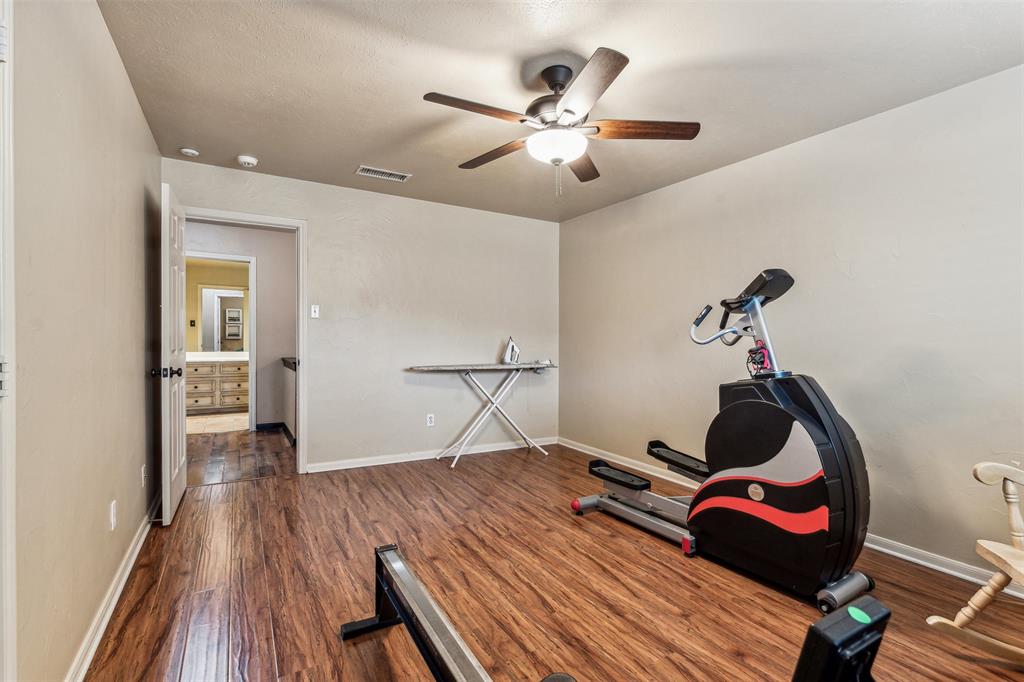 5109 Dewdrop Lane Fort Worth, TX 76123 - Photo 26 of 40 a bedroom with a bed and a chandelier