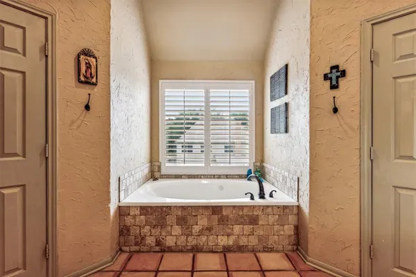 a bathroom with a bathtub and shower
