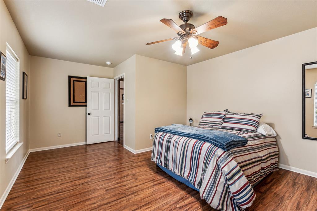 5109 Dewdrop Lane Fort Worth, TX 76123 - Photo 36 of 40 a bedroom with a bed and wooden floor
