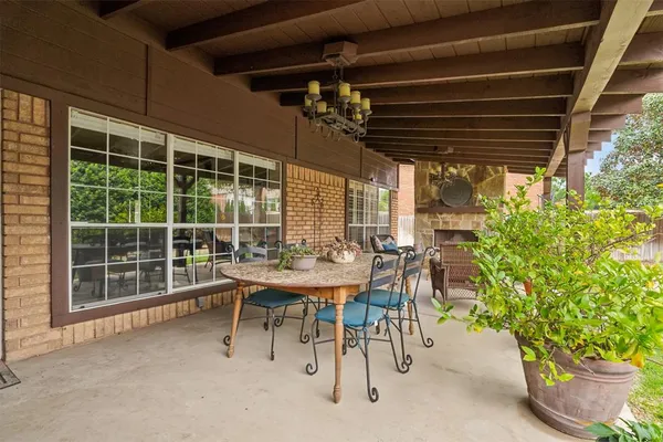 a view of an outdoor dining space with a table and chairs