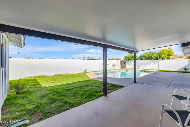 a view of a swimming pool with a yard