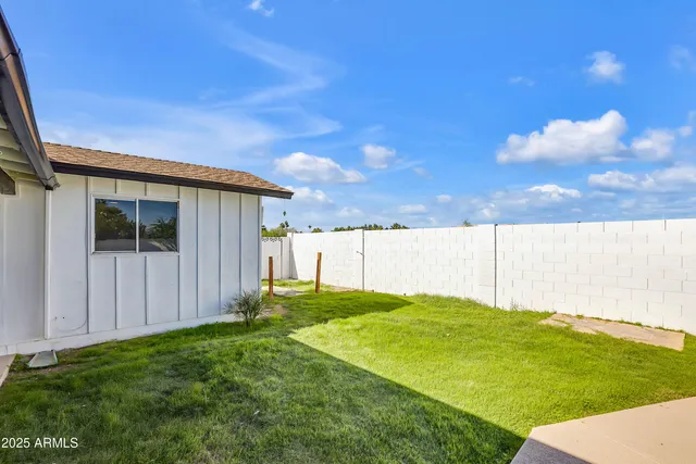 a front view of a house with swimming pool having outdoor seating