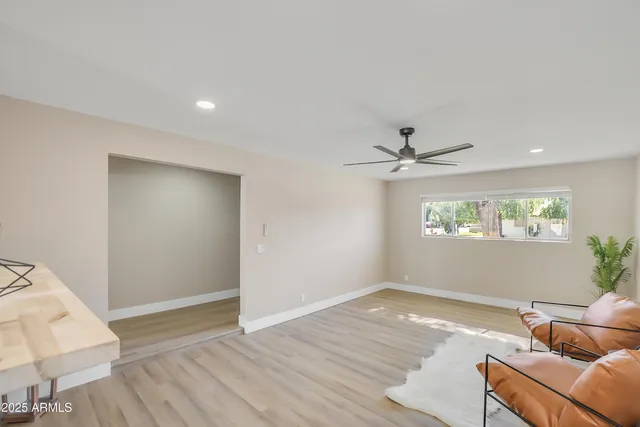 a kitchen with white cabinets appliances and wooden floor