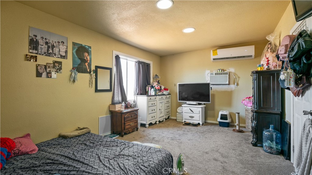 5737 Gammel Road Twentynine Palms, CA 92277 - Photo 14 of 48 a bedroom with a bed and a flat screen tv