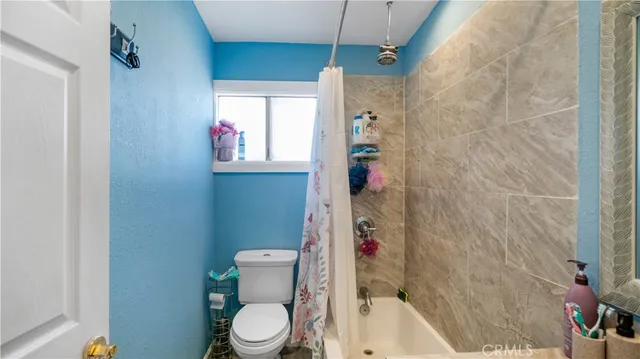 a bedroom with furniture and a flat screen tv