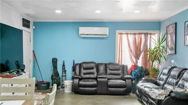 a living room with furniture a flat screen tv and a large window