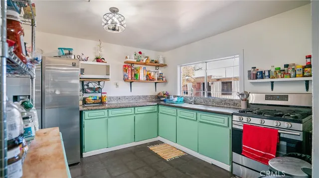 a kitchen with stainless steel appliances granite countertop a sink and cabinets