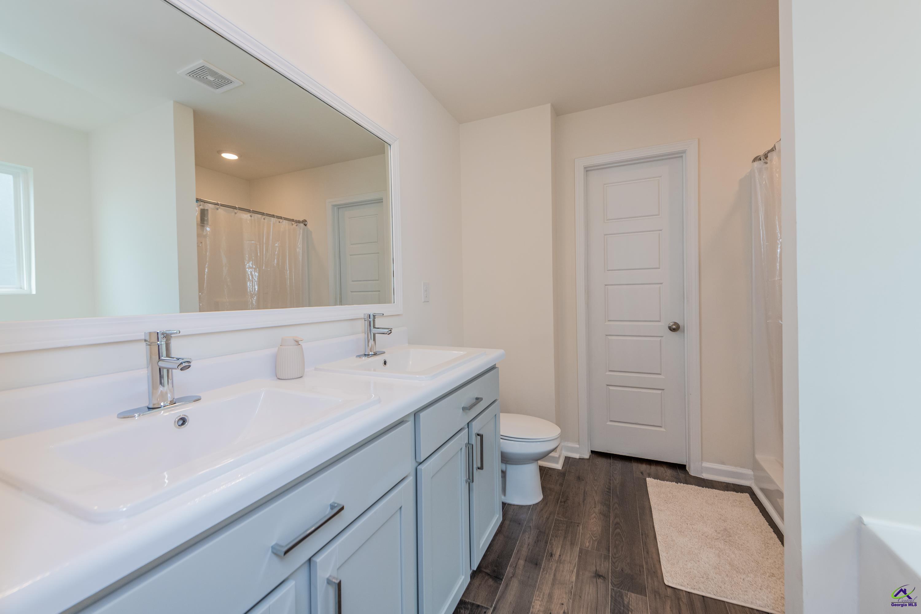 126 Farmers Way Perry, GA 31069 - Photo 17 of 39 a bathroom with a double vanity sink toilet and shower