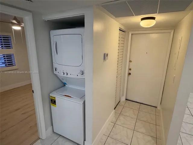 a utility room with cabinets washer and dryer