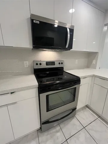 a kitchen with a stove and a microwave