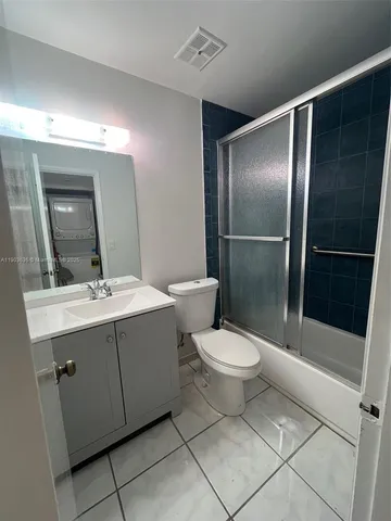 a bathroom with a double vanity sink toilet and shower