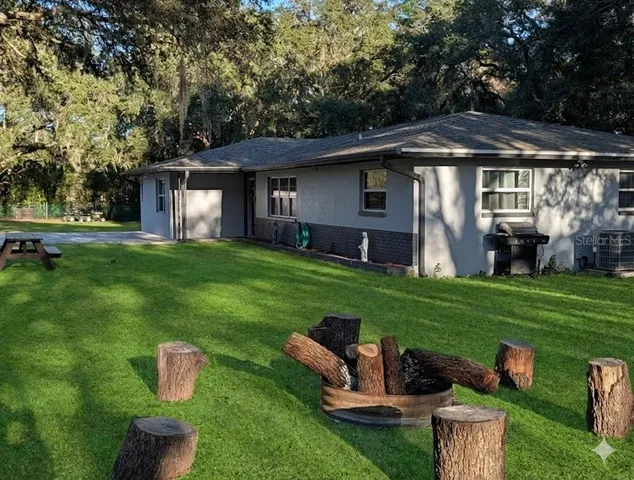 an empty room with closet and a ceiling fan