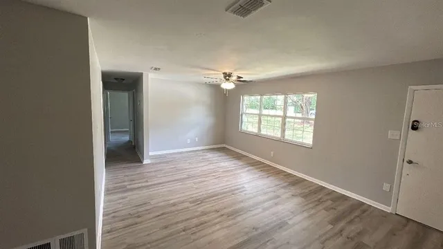 a backyard of a house with lots of green space and glass windows