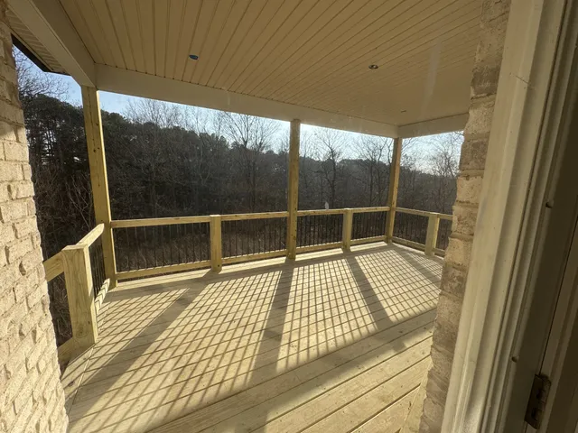 a view of wooden floor with a floor to ceiling window