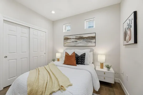 a bedroom with a bed and painting on the wall