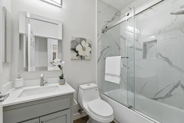 a white toilet sitting next to a bathroom sink