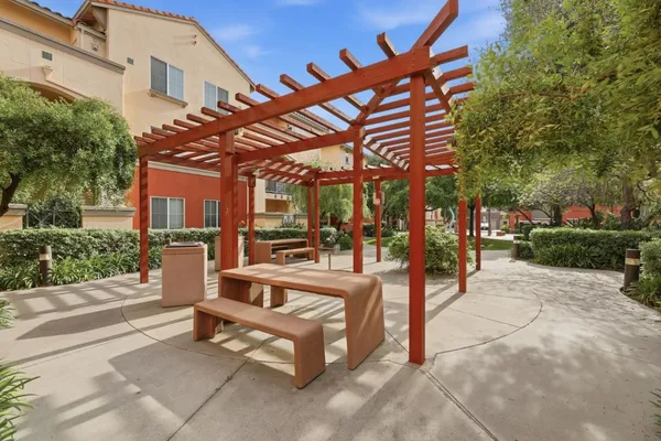 a view of a patio with a table and chairs and potted plants