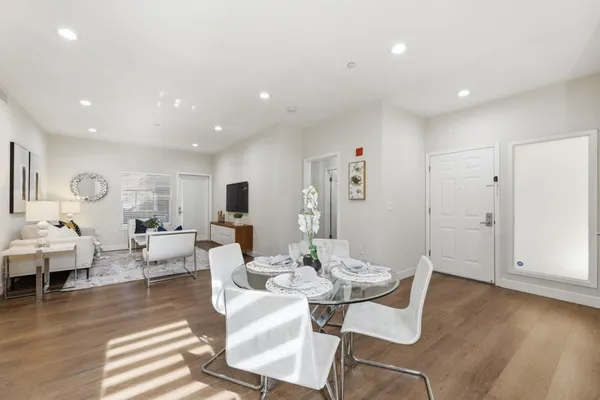 a living room with fireplace furniture and a wooden floor