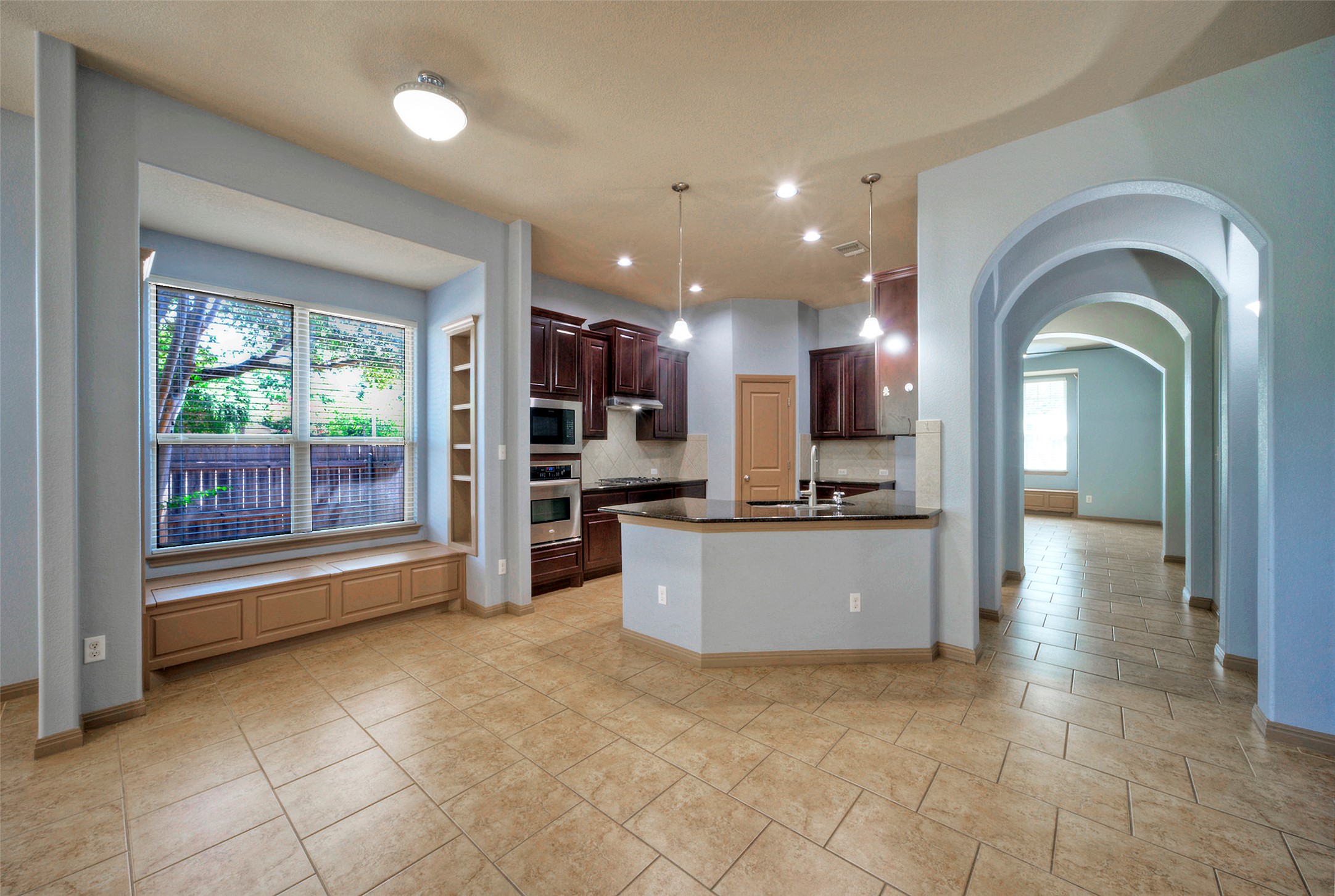 1601 Nelson Ranch Loop Cedar Park, TX 78613 - Photo 17 of 30 Tiled flooring and arched entryways frame this functional kitchen and casual dining space.