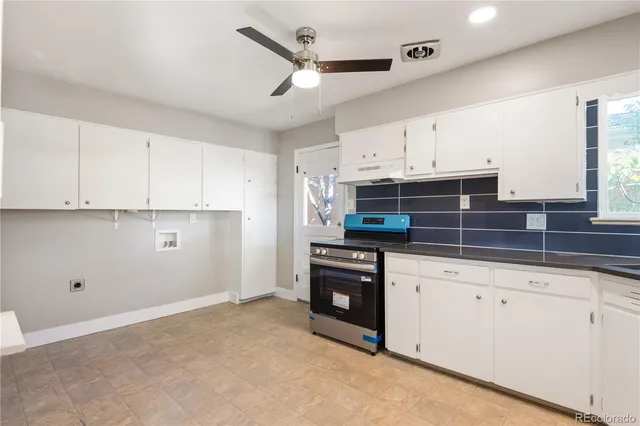 a kitchen with cabinets and window