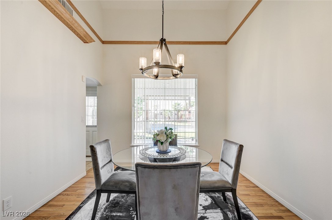 2955 El Camino Road Las Vegas, NV 89146 - Photo 40 of 99 Dining space with light wood-style floors, arched walkways, and a chandelier