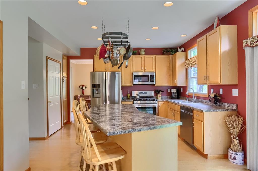 4014 Dickey Road Gibsonia, PA 15044 - Photo 12 of 50 a view of a kitchen with kitchen island granite countertop a sink appliances cabinets and a counter top space