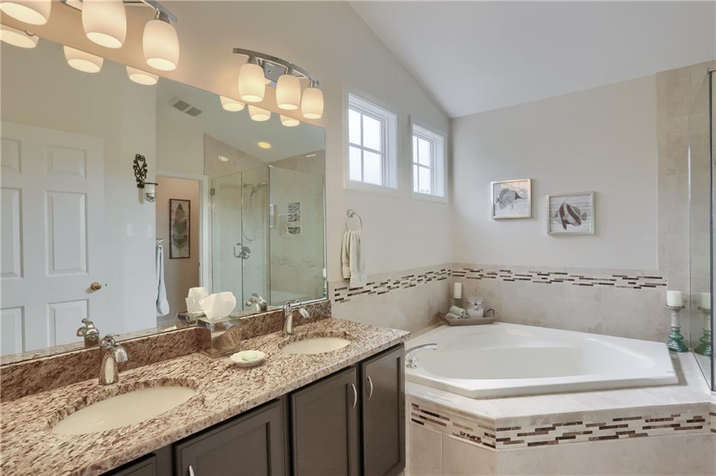4014 Dickey Road Gibsonia, PA 15044 - Photo 25 of 50 a bathroom with a granite countertop sink a large mirror and vanity