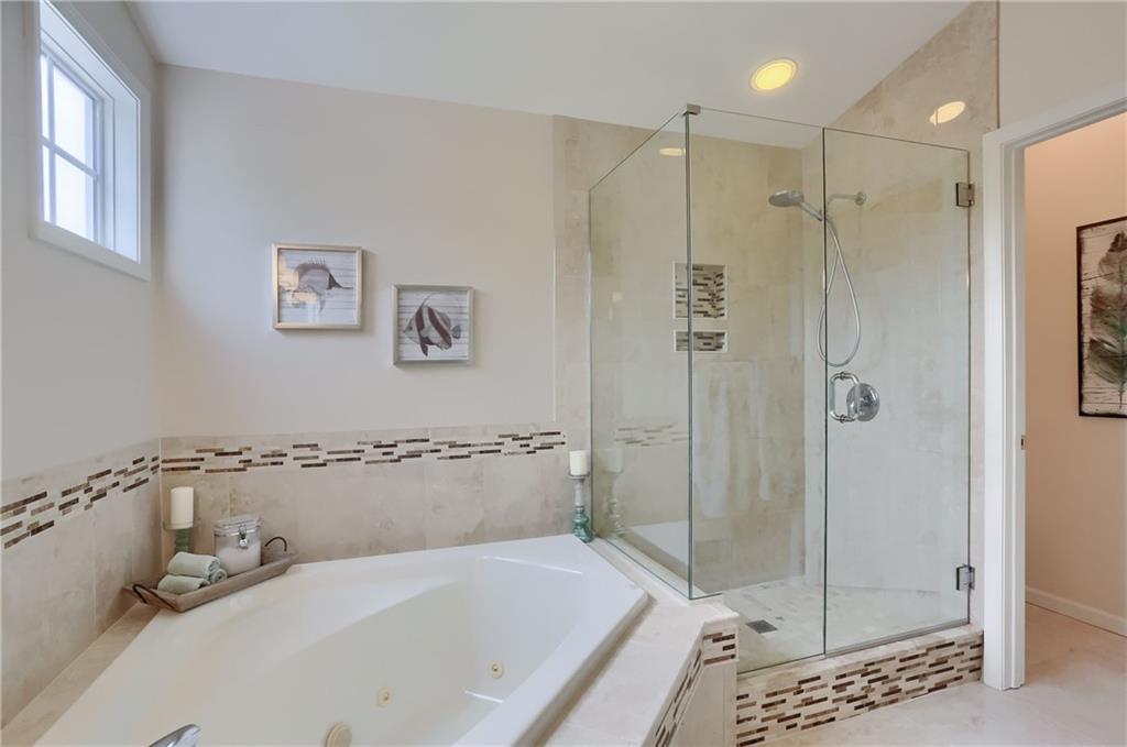 4014 Dickey Road Gibsonia, PA 15044 - Photo 26 of 50 a bathroom with a tub a sink and glass door shower