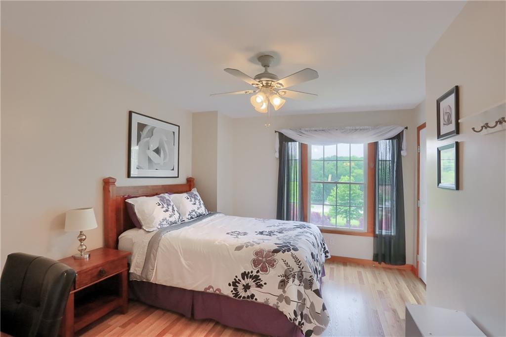 4014 Dickey Road Gibsonia, PA 15044 - Photo 27 of 50 a bedroom with a large bed and a chandelier