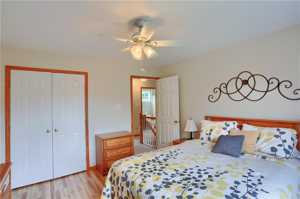 4014 Dickey Road Gibsonia, PA 15044 - Photo 28 of 50 a bedroom with a large bed and a chandelier