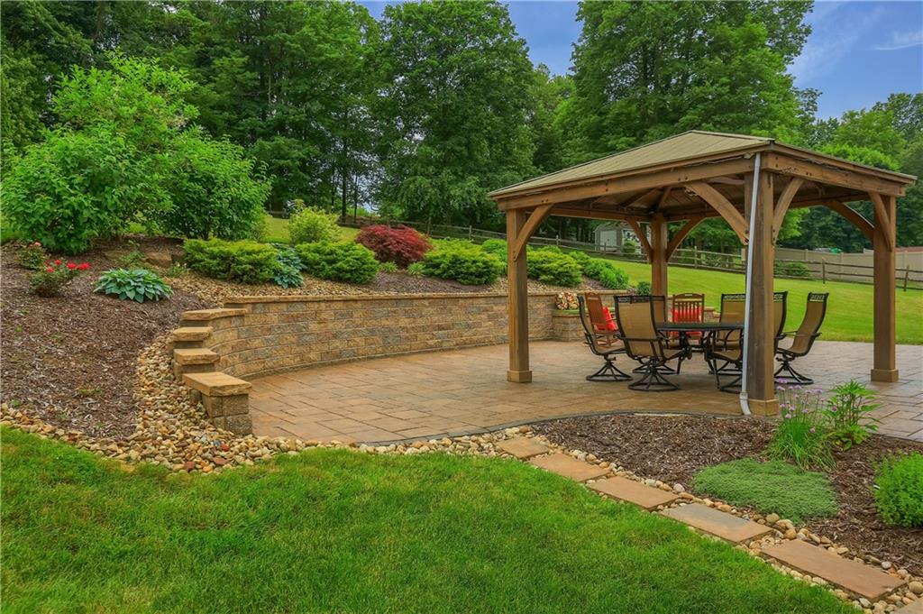 4014 Dickey Road Gibsonia, PA 15044 - Photo 44 of 50 a view of backyard with table and chairs under an umbrella