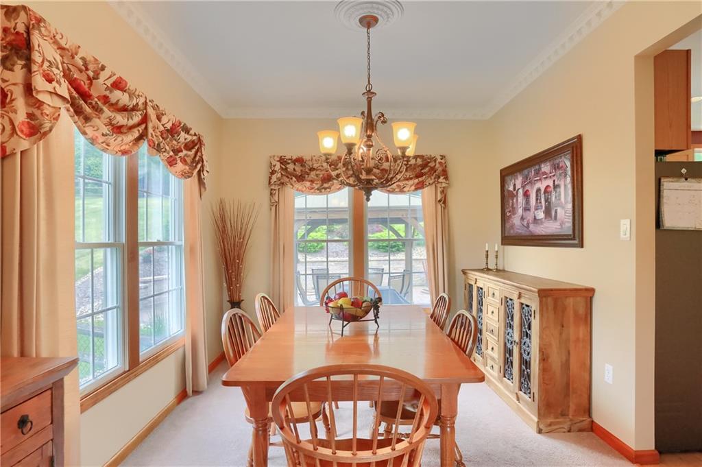 4014 Dickey Road Gibsonia, PA 15044 - Photo 8 of 50 a view of a dining room with furniture a chandelier and large windows