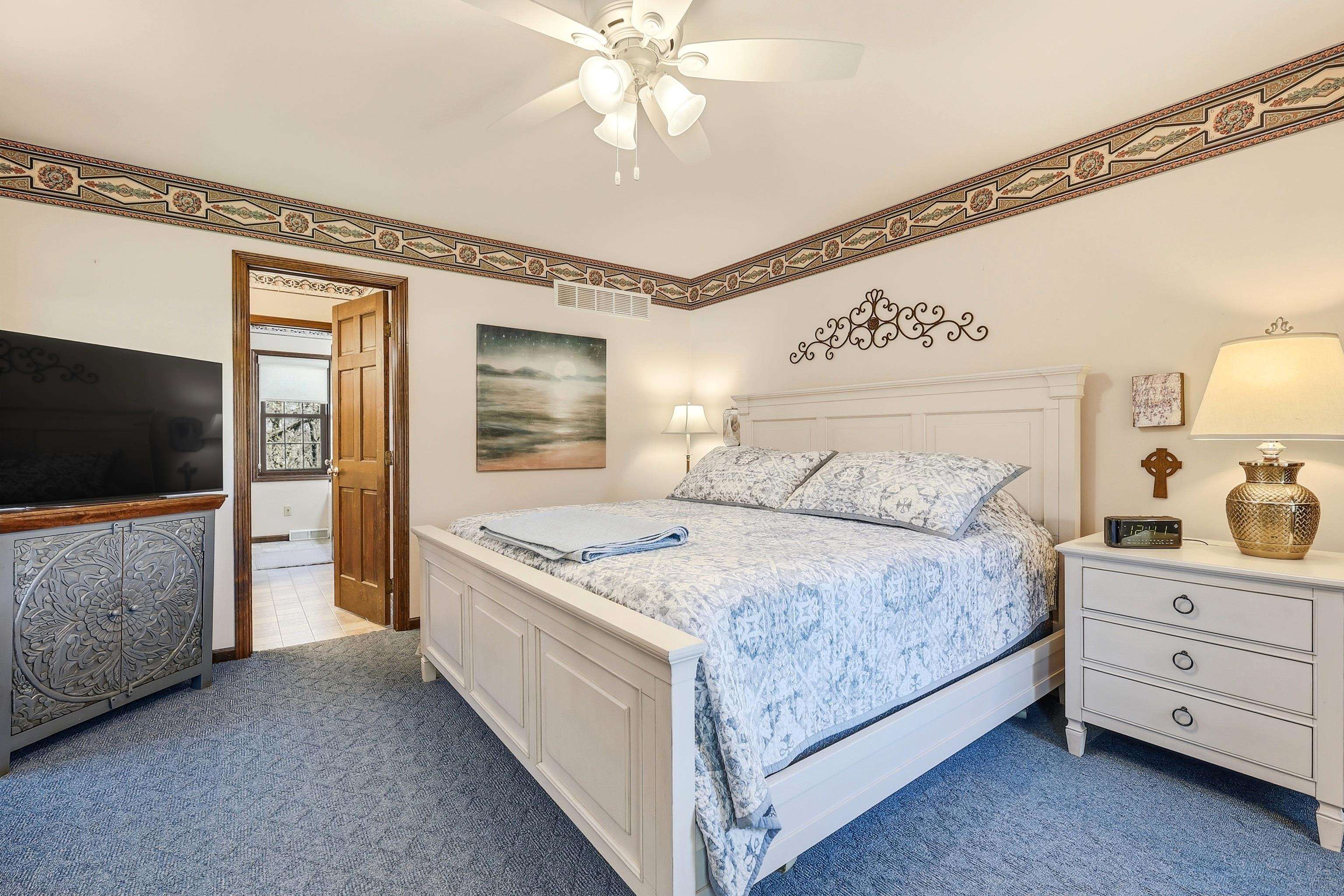 1967 East Cross Road Galena, IL 61036 - Photo 27 of 51 a spacious bedroom with a bed and a flat screen tv