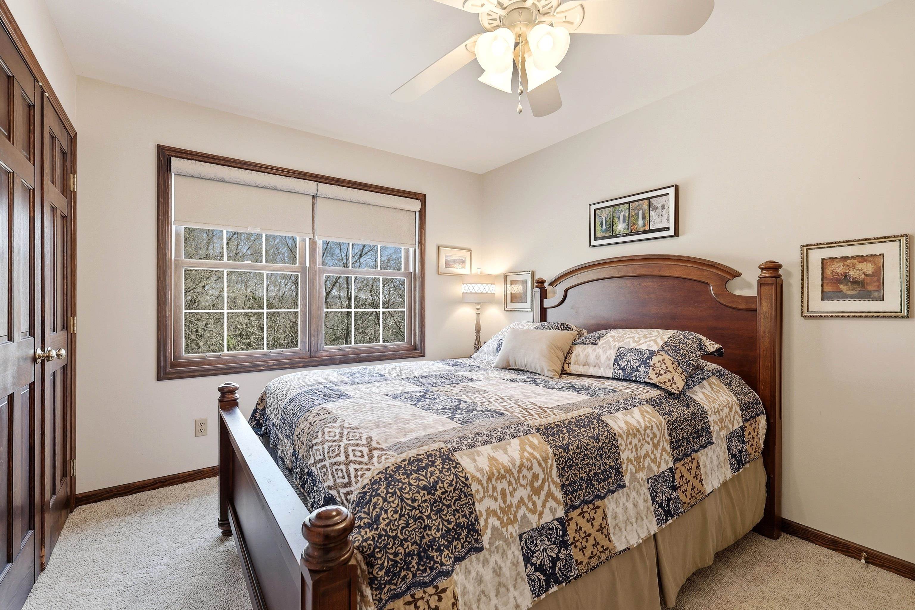 1967 East Cross Road Galena, IL 61036 - Photo 35 of 51 a bedroom with a large bed and a chandelier