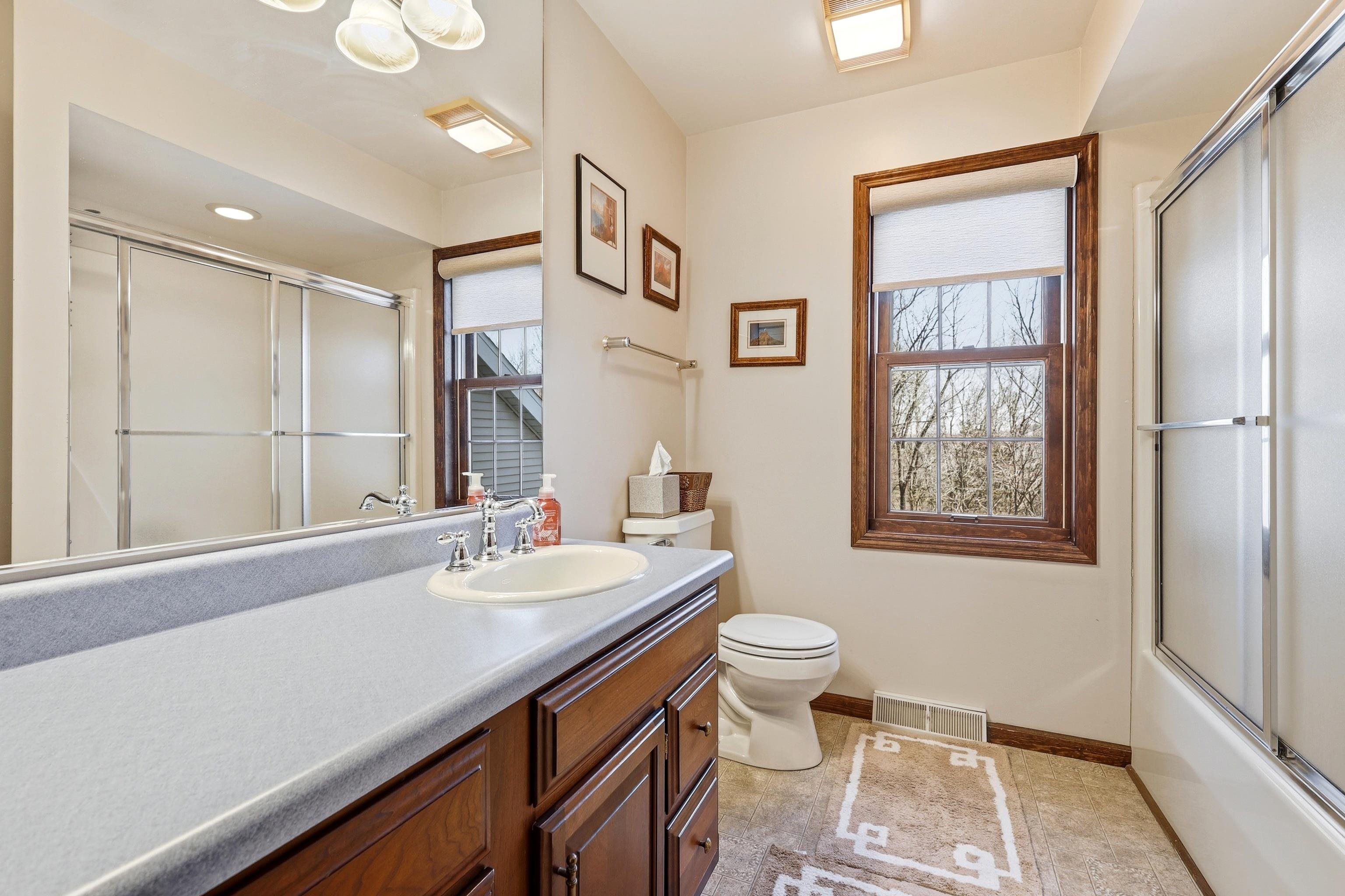 1967 East Cross Road Galena, IL 61036 - Photo 43 of 51 a bathroom with a sink a toilet and a large mirror