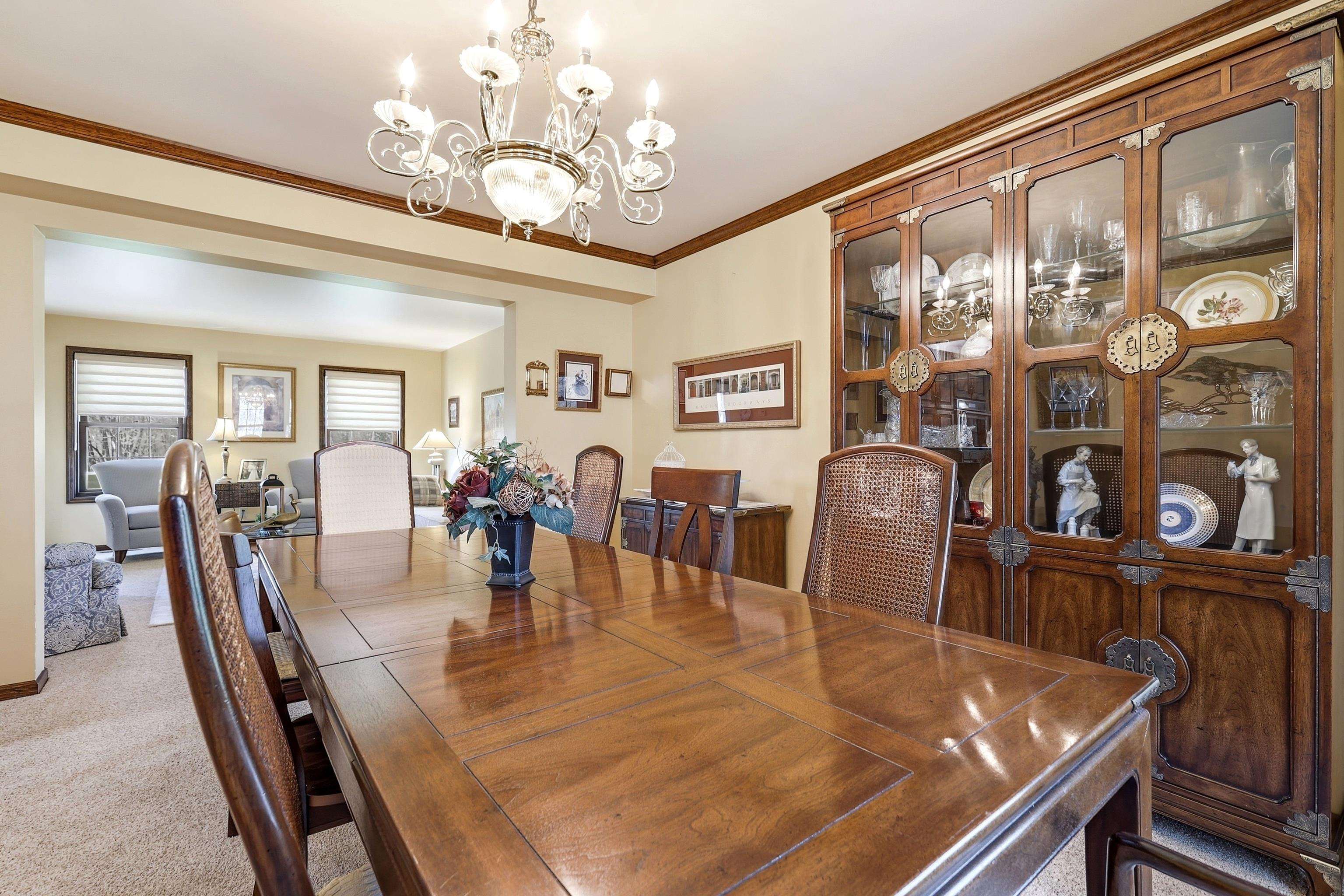 1967 East Cross Road Galena, IL 61036 - Photo 7 of 51 a dining room with wooden floor chandelier and glass windows