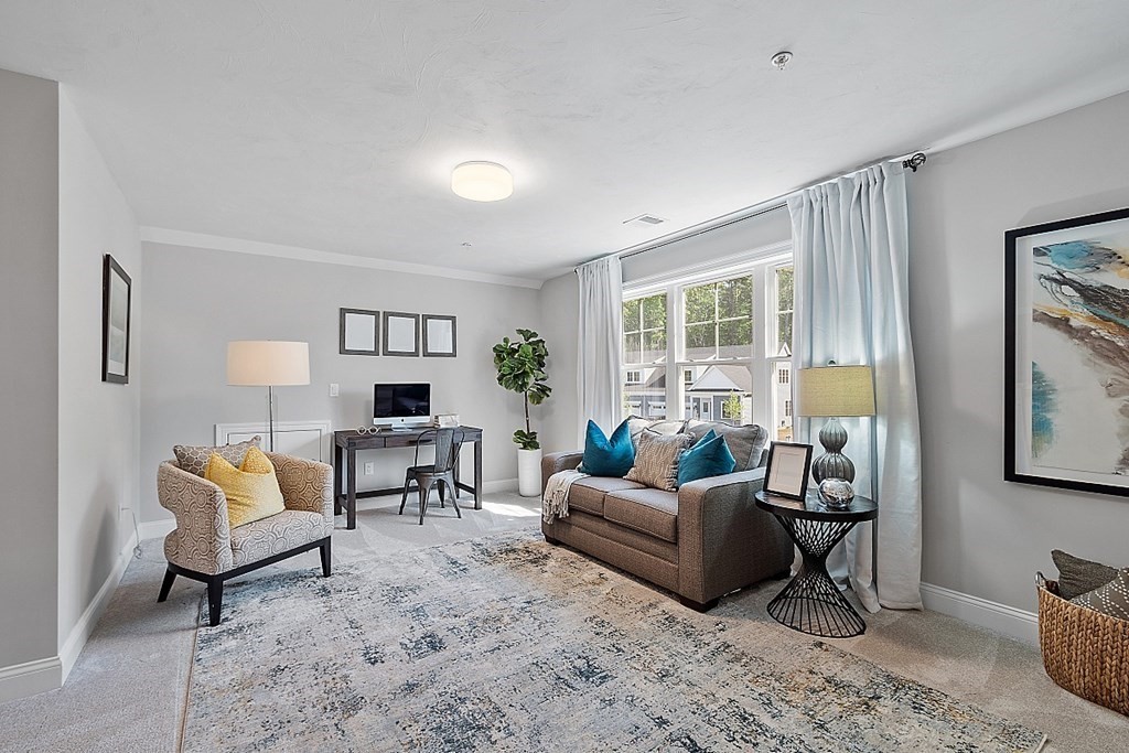 30 Wheeler Hill Road, Unit 61 Berlin, MA 01503 - Photo 17 of 31 a living room with furniture and a window
