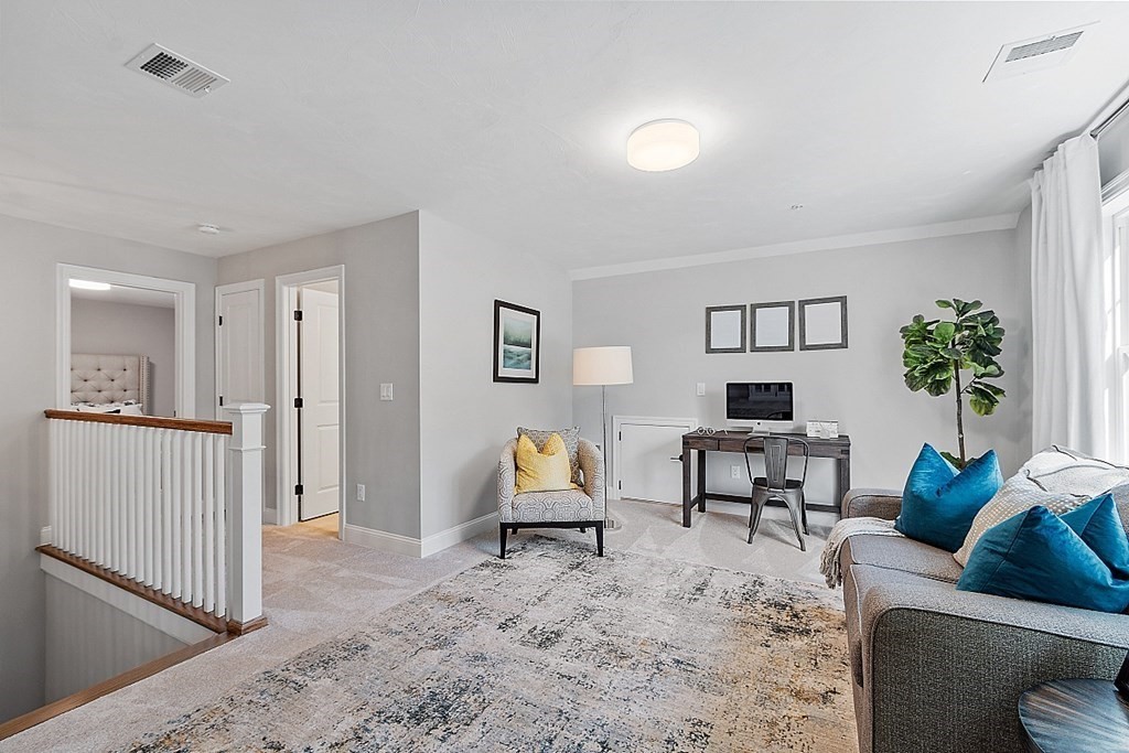 30 Wheeler Hill Road, Unit 61 Berlin, MA 01503 - Photo 18 of 31 a living room with furniture and a potted plant