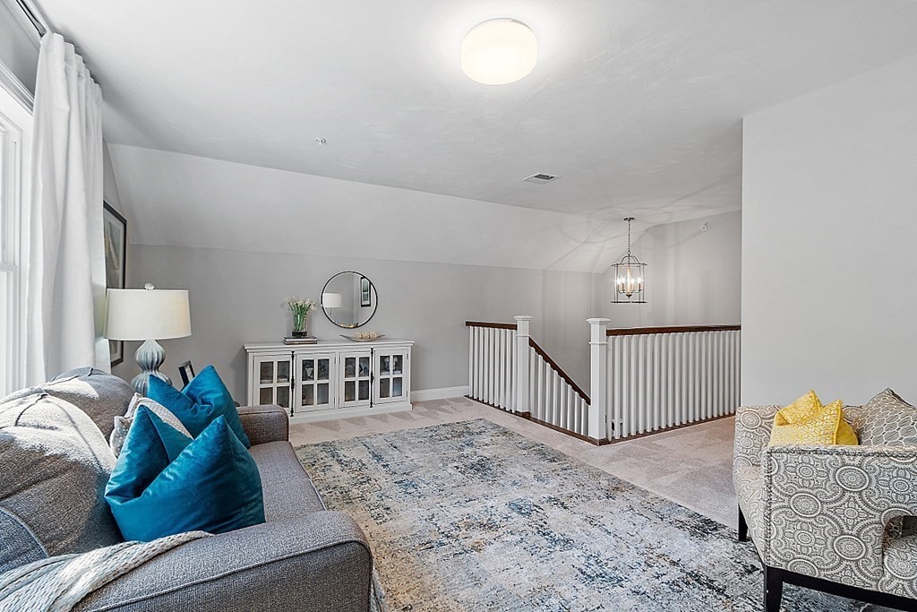 30 Wheeler Hill Road, Unit 61 Berlin, MA 01503 - Photo 19 of 31 a living room with furniture and a window