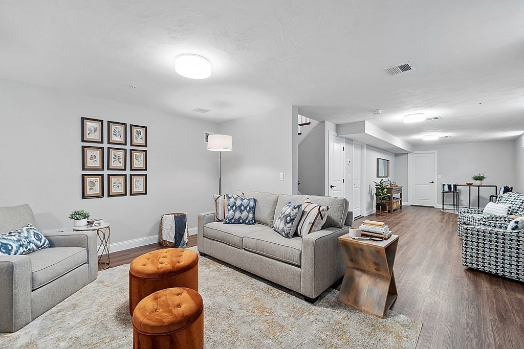 30 Wheeler Hill Road, Unit 61 Berlin, MA 01503 - Photo 23 of 31 a living room with furniture and a wooden floor