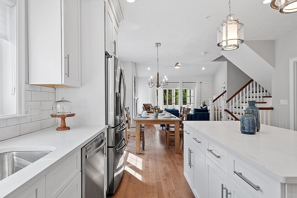 30 Wheeler Hill Road, Unit 61 Berlin, MA 01503 - Photo 3 of 31 a kitchen with sink cabinets and wooden floor